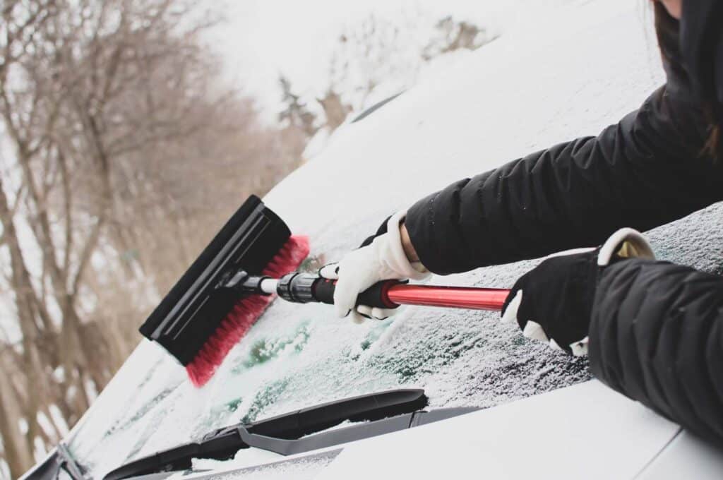 Clearing Snow Off Car Windshield