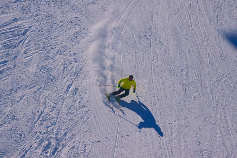 Person With Yellow Jacket Skiing