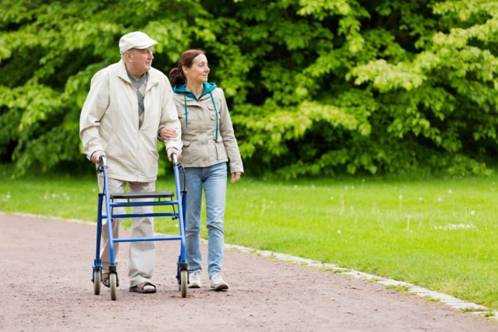 Elderly Person Being Assisted While Walking