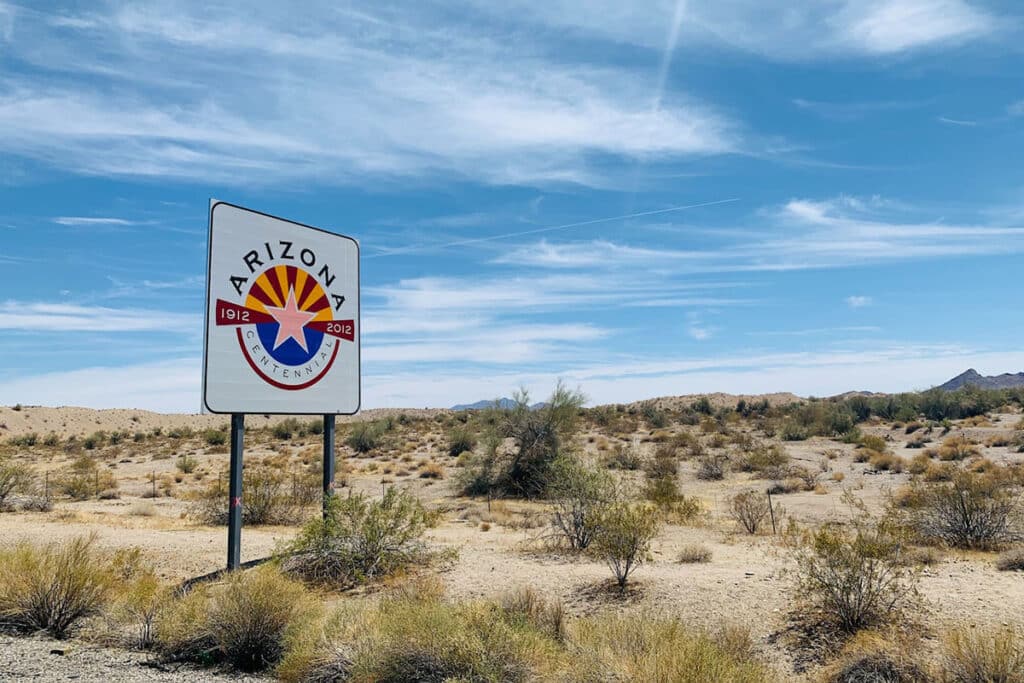 Arizona Sign in the Desert Near Shrubs